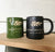 Black and green mugs with the Northlight Interiors logo on a wood board.