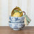 Vintage style blue and white floral designed ceramic bowls stacked on table with linens. 