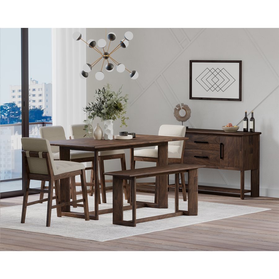 Veneered chocolate brown wood gathering bench in dining room. Matching table and chairs displayed. 