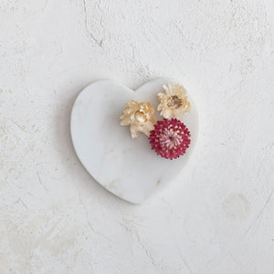 Heart shaped white marble soap dish with dried florals displayed. Kitchen and bathroom home decor. 