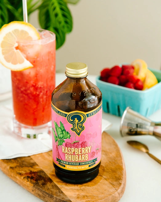 Amber glass bottle of organic Raspberry Rhubarb simple syrup. Portland Syrups. 