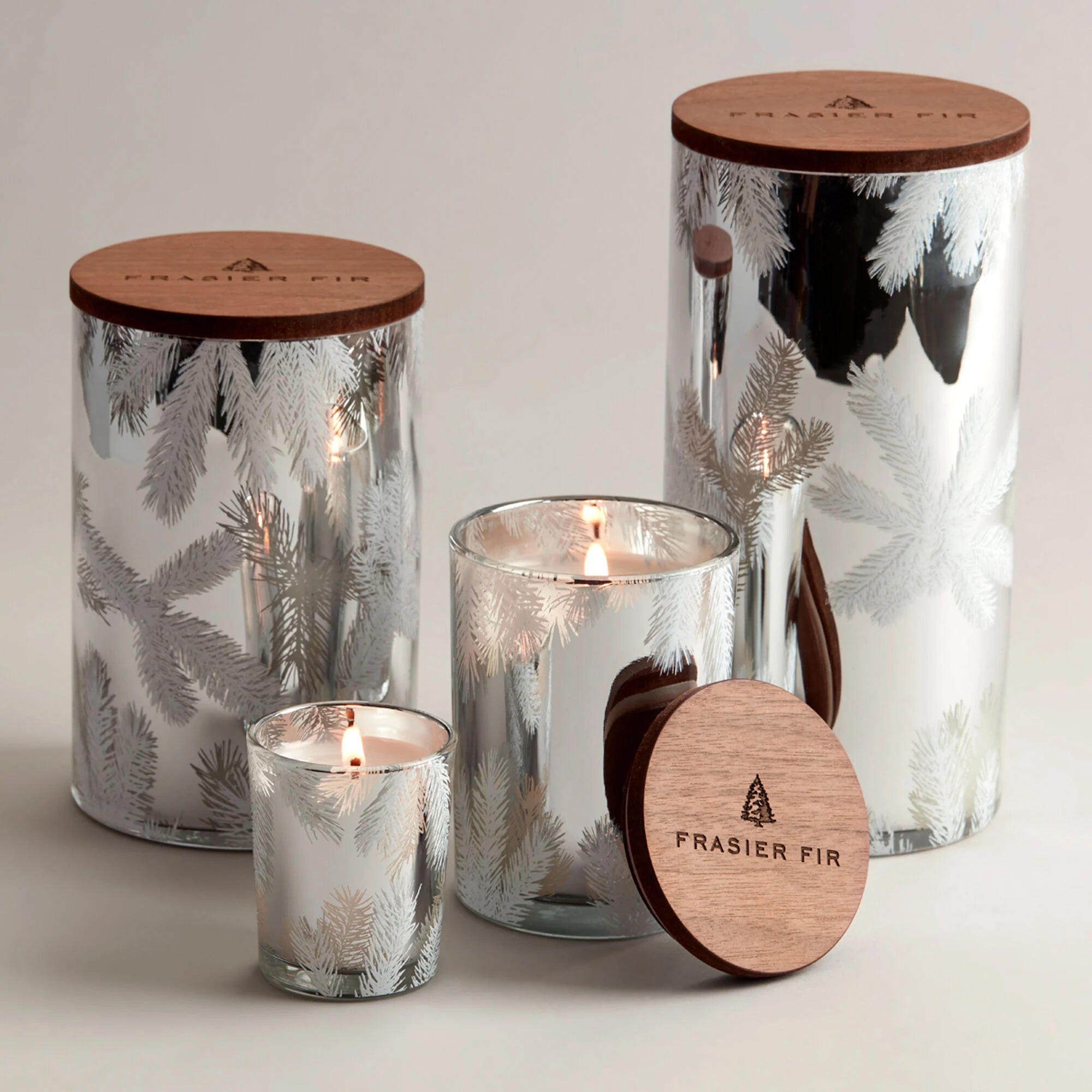 Frasier Fir silver statement holiday collection. Various sized candles displayed. 