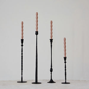 Varying height and styles of hand forged black cast iron taper candle holders. 