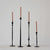 Varying height and styles of hand forged black cast iron taper candle holders. 