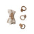set of four natural handmade bamboo napkin rings displayed on white linen cloth. 