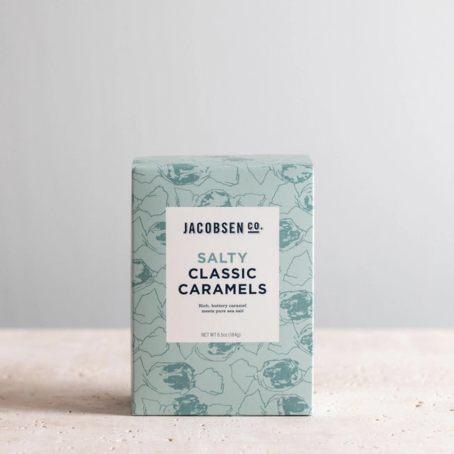 Box of Jacobsen salty classic caramels on white stone counter.