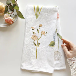 Garden flowers tea towel folded  in half with watercolor rose print. 