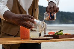 Person using Jacobsen habanero salt to rim a margarita glass.