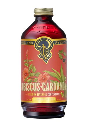 The Hibiscus Cardamom Syrup bottle with a red and gold label.