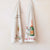 Cotton slub tea towels hung on wall in two different holiday designs. 