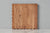 Individual acacia wood scalloped cutting board displayed face up. Hand made in India. 
