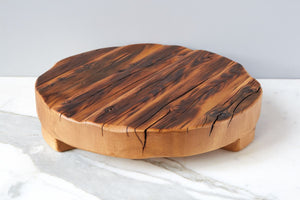 Side profile of reclaimed wood trivet displayed against marble countertop. Live edge, natural grooves, wood beam kitchen trivet. 