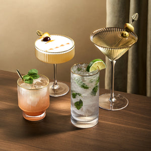 Four different meridian glasses with different cocktails in each.