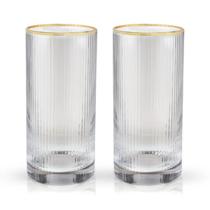 Two empty meridian fluted highball glasses with gold rims.