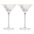 Two empty meridian fluted martini glasses with gold rims.