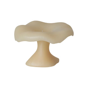 Large creamy white mushroom candle with a droopy flat top.