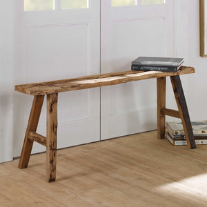 Wood bench in a white entry with books on the end.