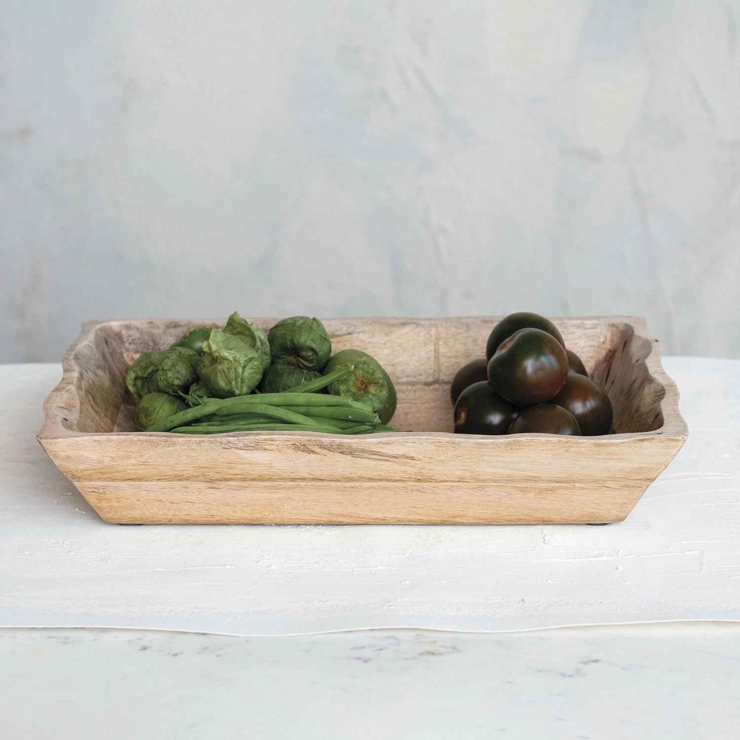 scalloped mango wood tray with food displayed inside. Food safe. 
