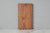 rectangular scalloped edge acacia wood cutting board displayed standing up. Handmade in India. Old world charm kitchen decor. 
