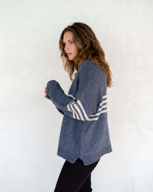 Side profile of Seacoast stripe sweater in blue. One size fits most, small side slit. Mersea. 