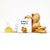 White Simply Mints Ginger container with whole and sliced ginger and white mortar and pestle.