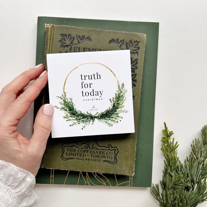 Truth for Today Christmas card set on top of green books.